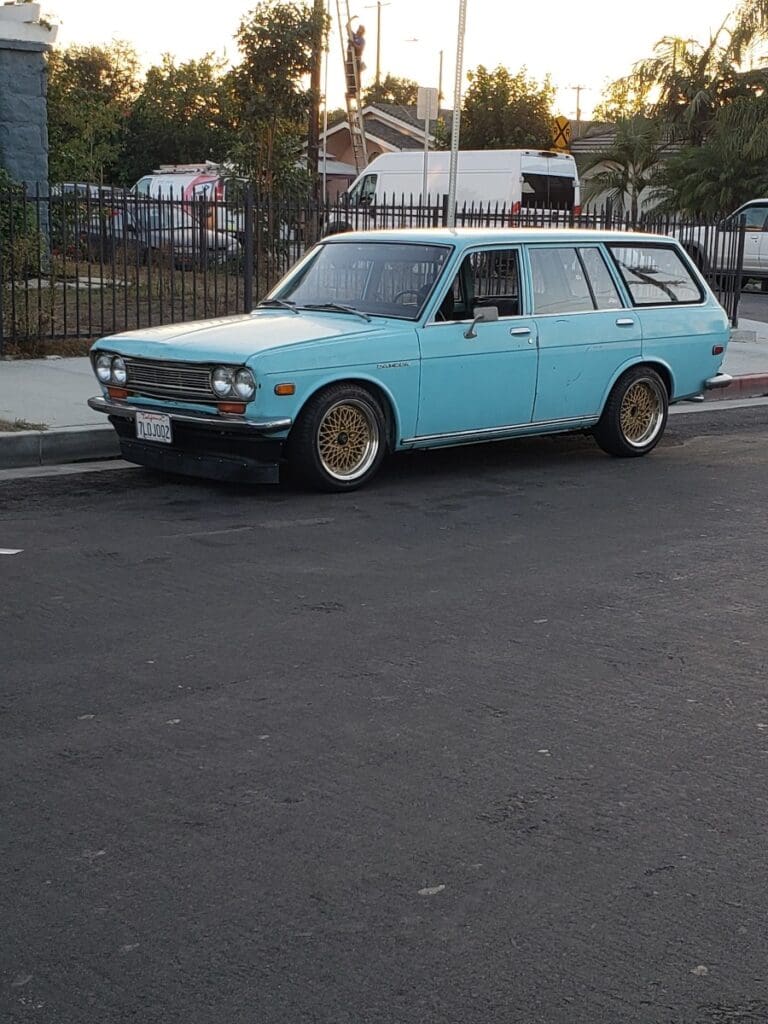 Light blue vintage station wagon parked on the street.