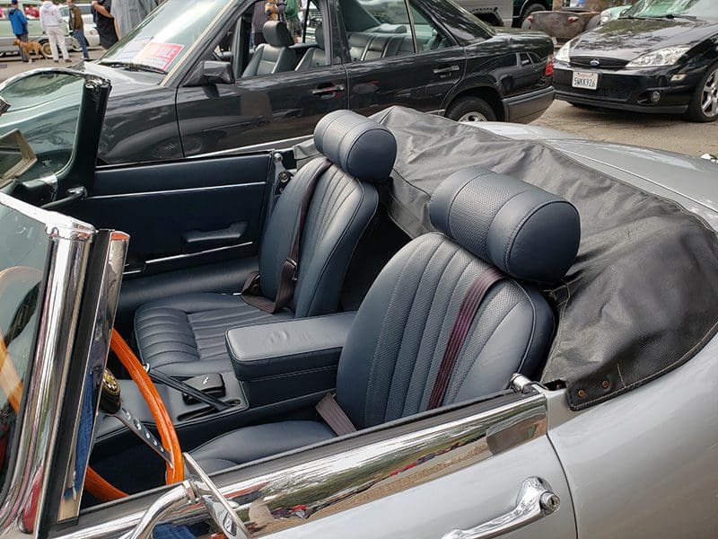 Interior of a classic convertible car with black leather seats.