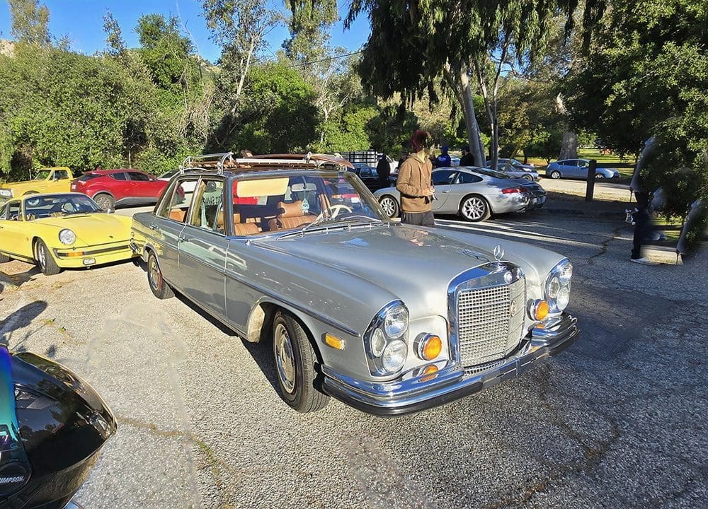 Classic silver Mercedes-Benz convertible parked outdoors.