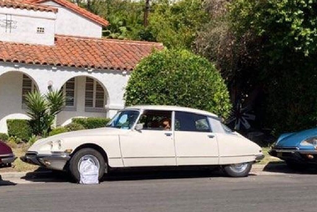 Classic vintage car parked on a sunny street.