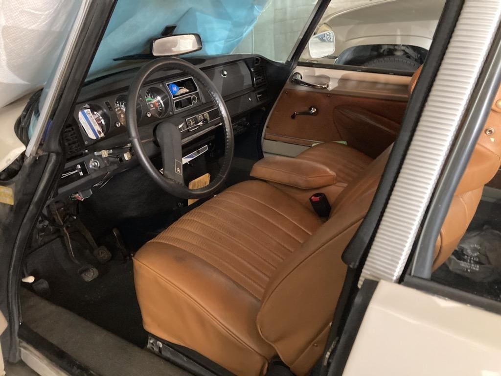 Interior of a car with brown leather seats and a black steering wheel.