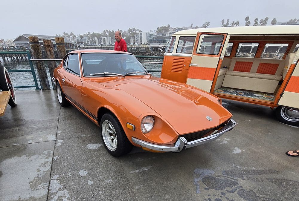 Classic orange sports car with a sleek design and pop-up headlights.