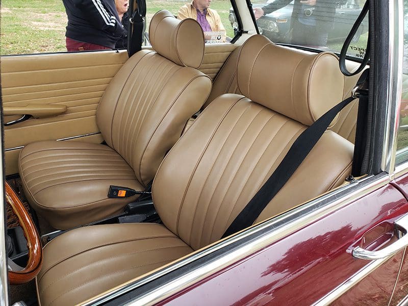 Close-up of tan leather seats in a classic car interior.