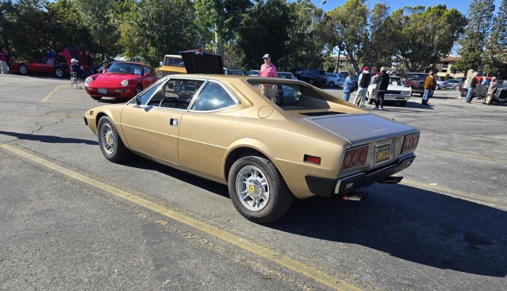 Classic gold AMC Gremlin parked outdoors on a sunny day.