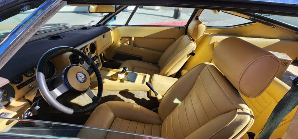 Luxurious beige leather car interior with modern dashboard and steering wheel.