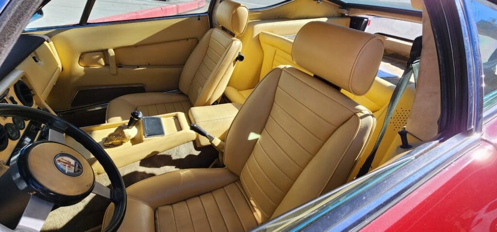 Luxurious tan leather car seats in a classic vehicle interior.
