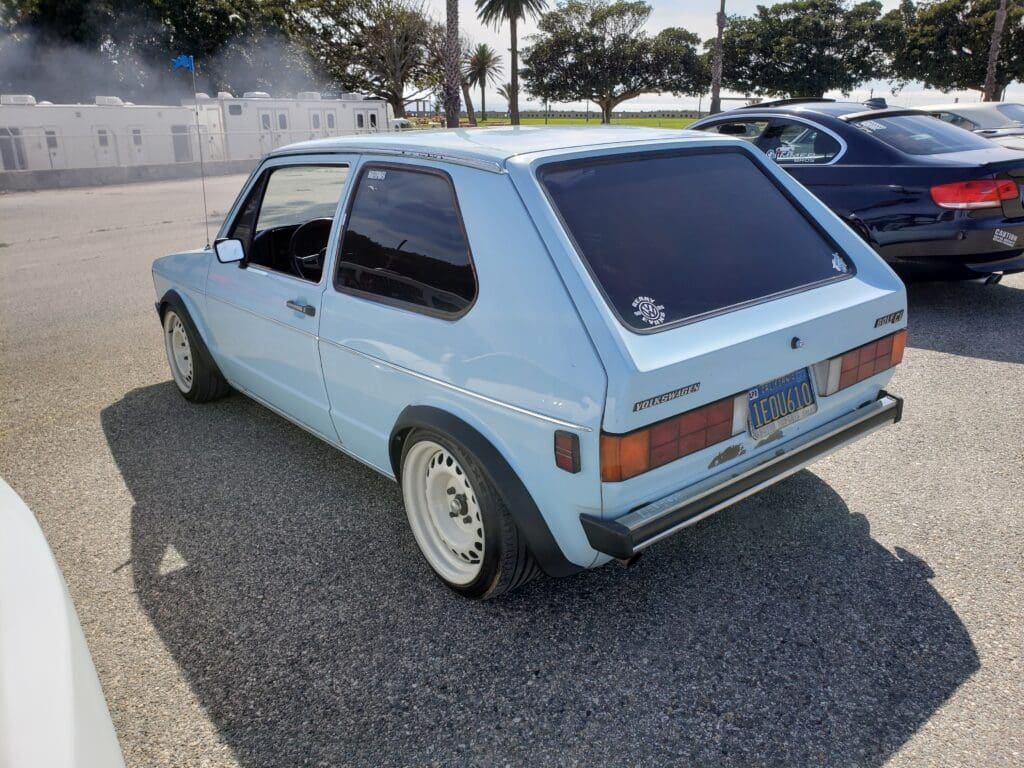 Classic light blue Volkswagen Golf parked outdoors on a sunny day.
