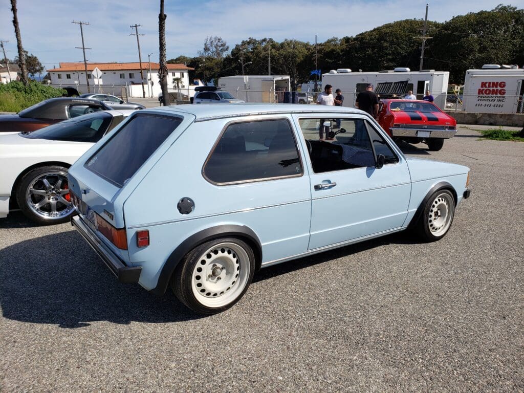 Classic light blue Volkswagen Golf parked outdoors on a sunny day.