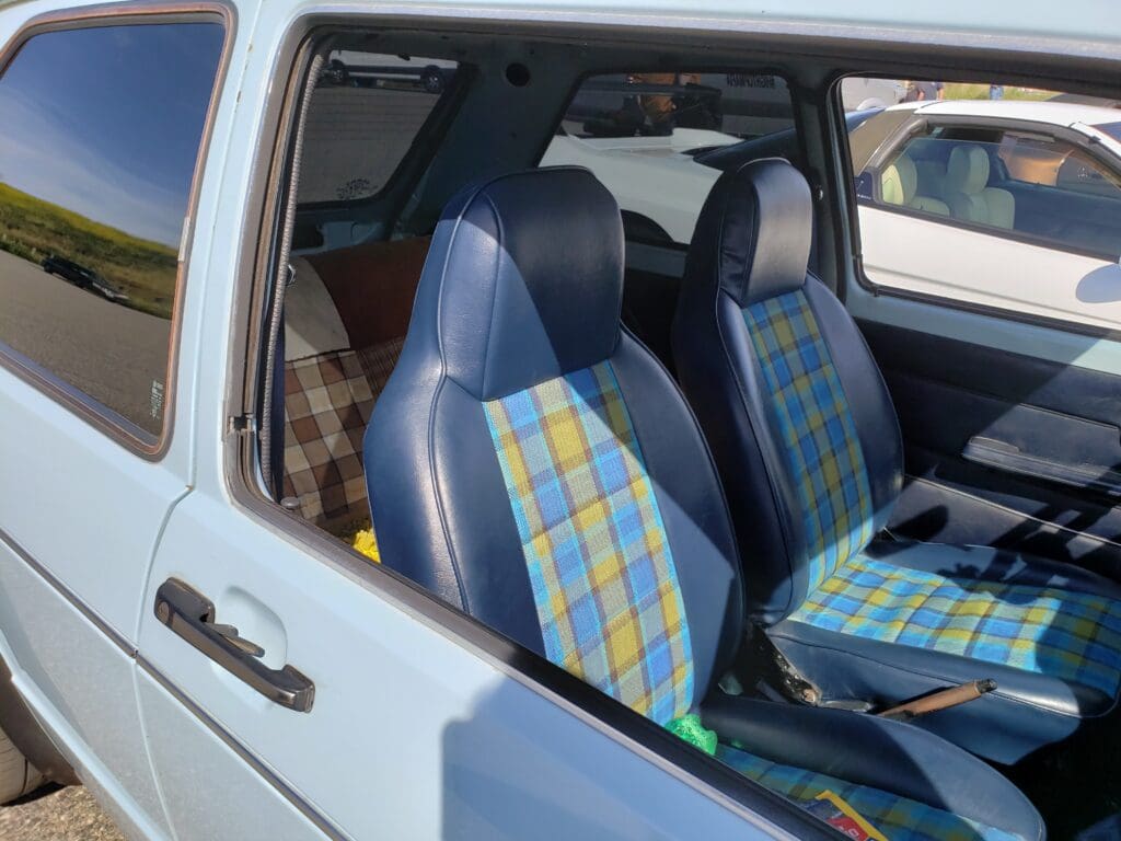 Car interior with blue and yellow plaid seat covers.