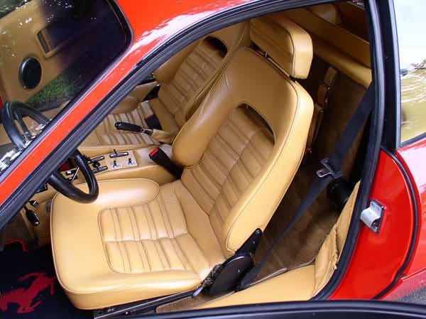 Luxurious tan leather car seat in a classic vehicle.