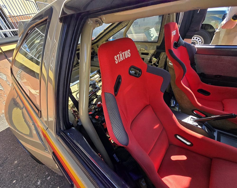 Red Sparco racing seats inside a car.