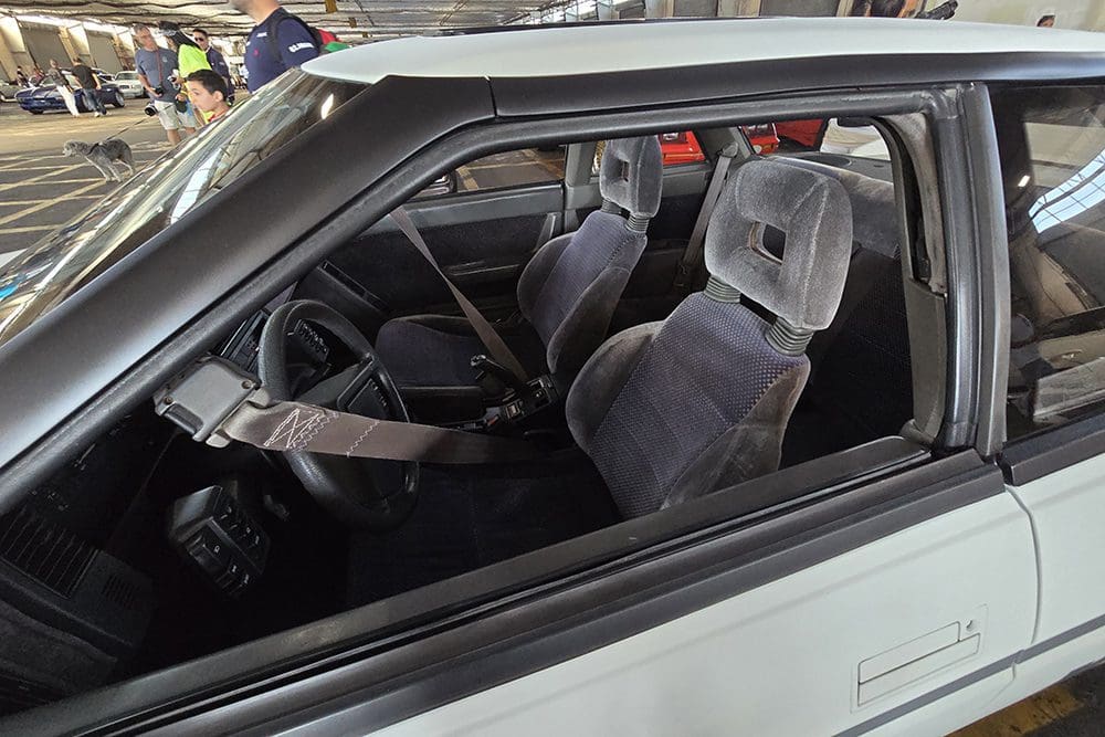Interior view of a car showing the front seats and steering wheel.