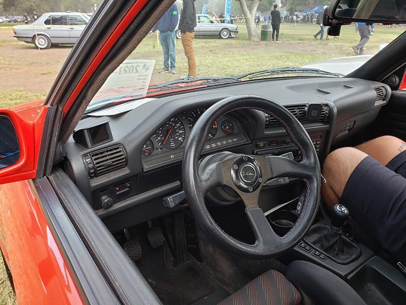 Interior view of a car focusing on the steering wheel and dashboard.