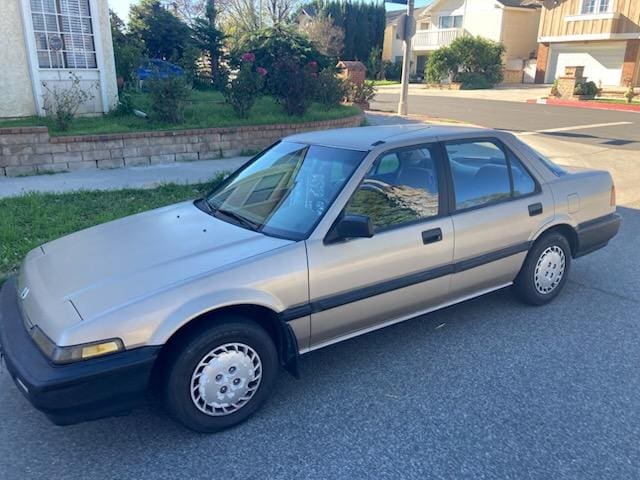 A silver four-door sedan parked on a residential street.