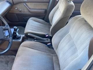 Interior view of a car showing front seats and center console.