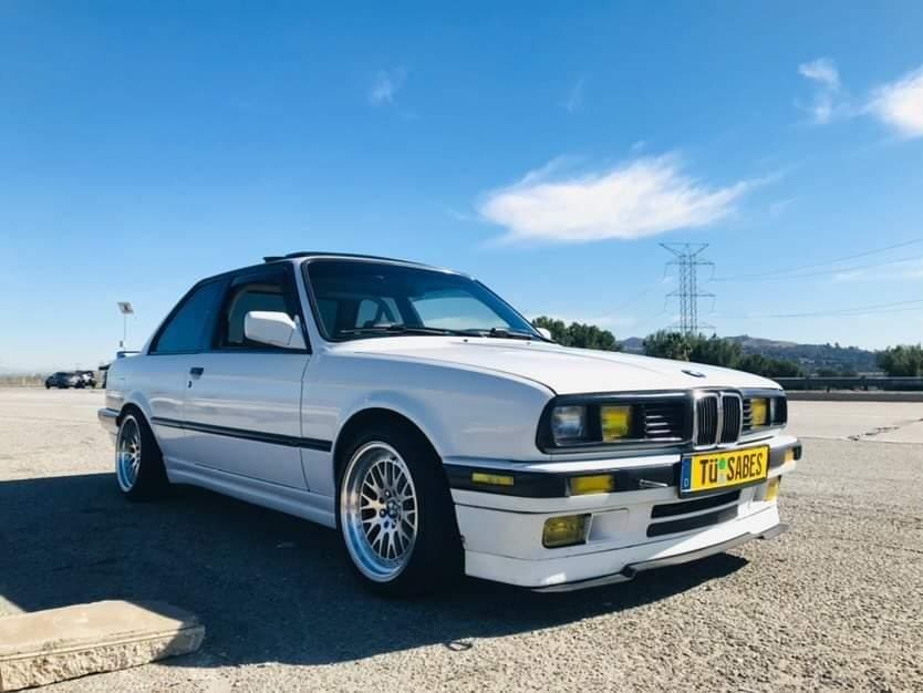 Classic white BMW coupe parked on a sunny day.