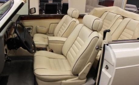 Luxurious beige leather car seats inside a classic vehicle.