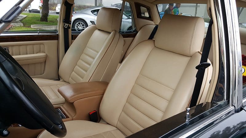 Beige leather car seats with a sleek, modern design.