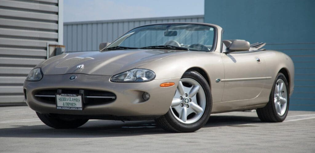 A sleek beige convertible sports car parked outdoors.