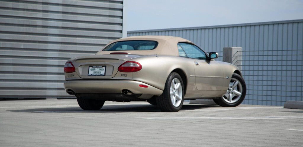 Classic tan convertible car parked on rooftop.