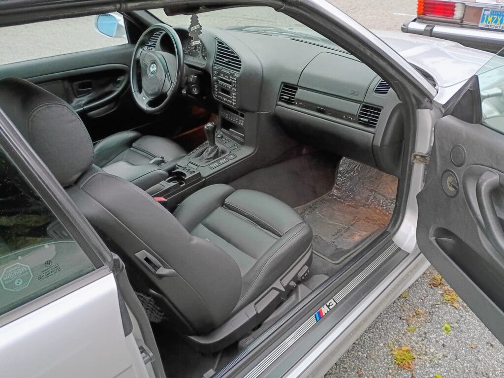 Clean interior of a modern car with leather seats and automatic transmission.