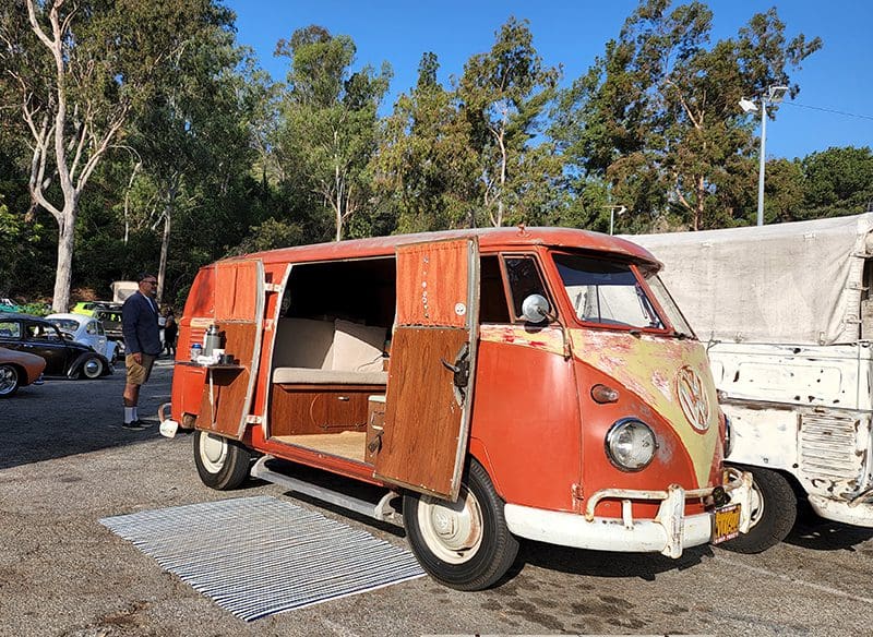 Vintage orange van with open doors.