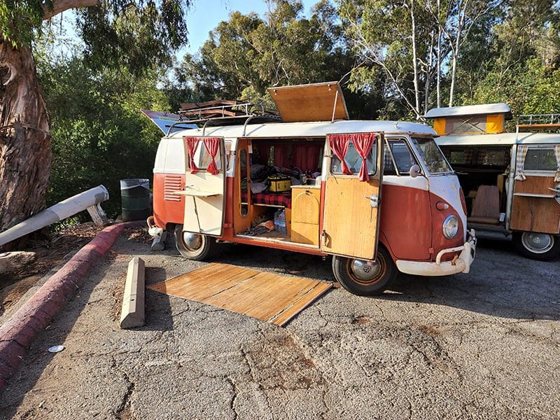 Vintage camper van parked with doors open.