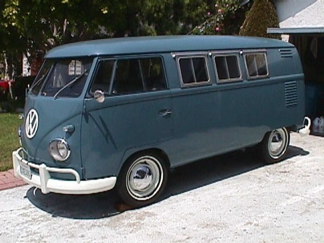 Vintage blue Volkswagen van parked outside.