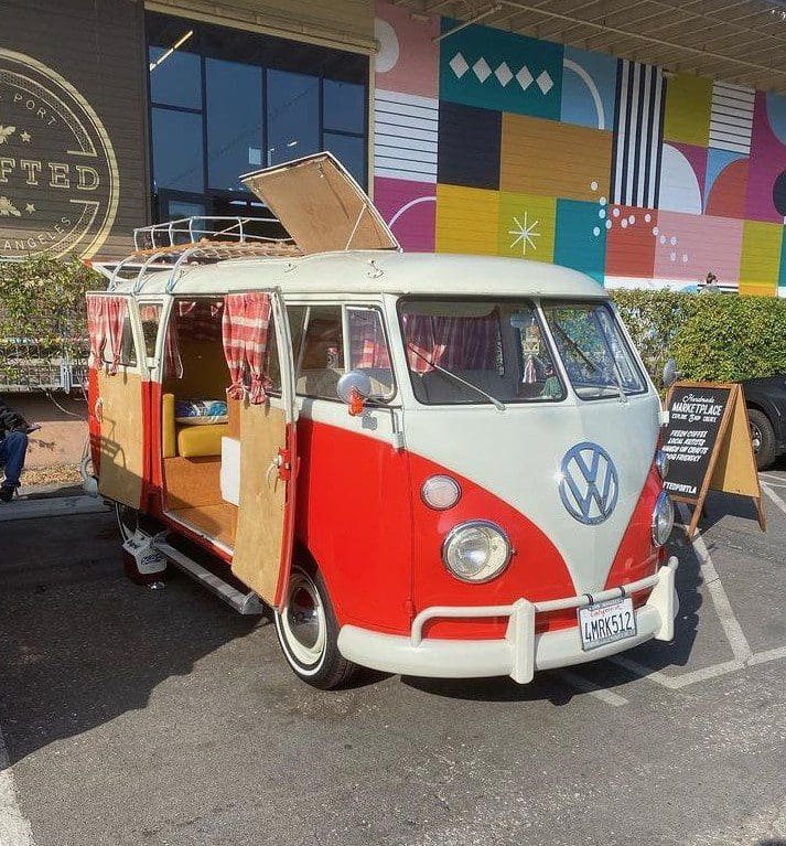 Vintage red and white Volkswagen van parked.
