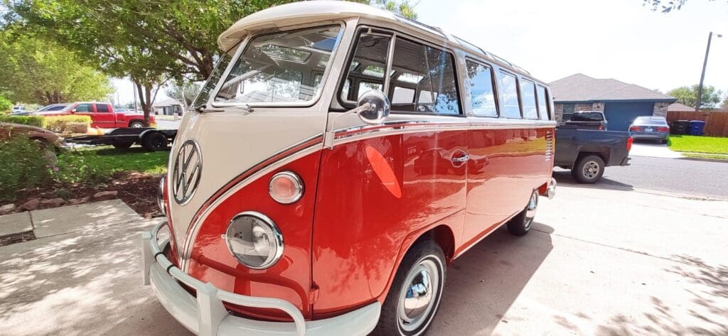 Red and white vintage Volkswagen van parked.