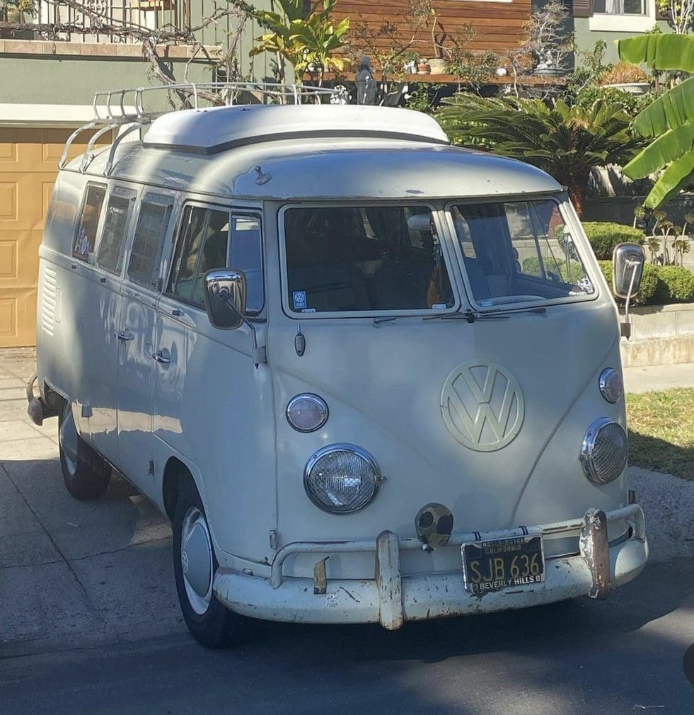 Vintage white Volkswagen van parked outside.