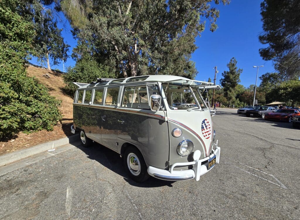 Vintage van parked in sunny outdoor setting.