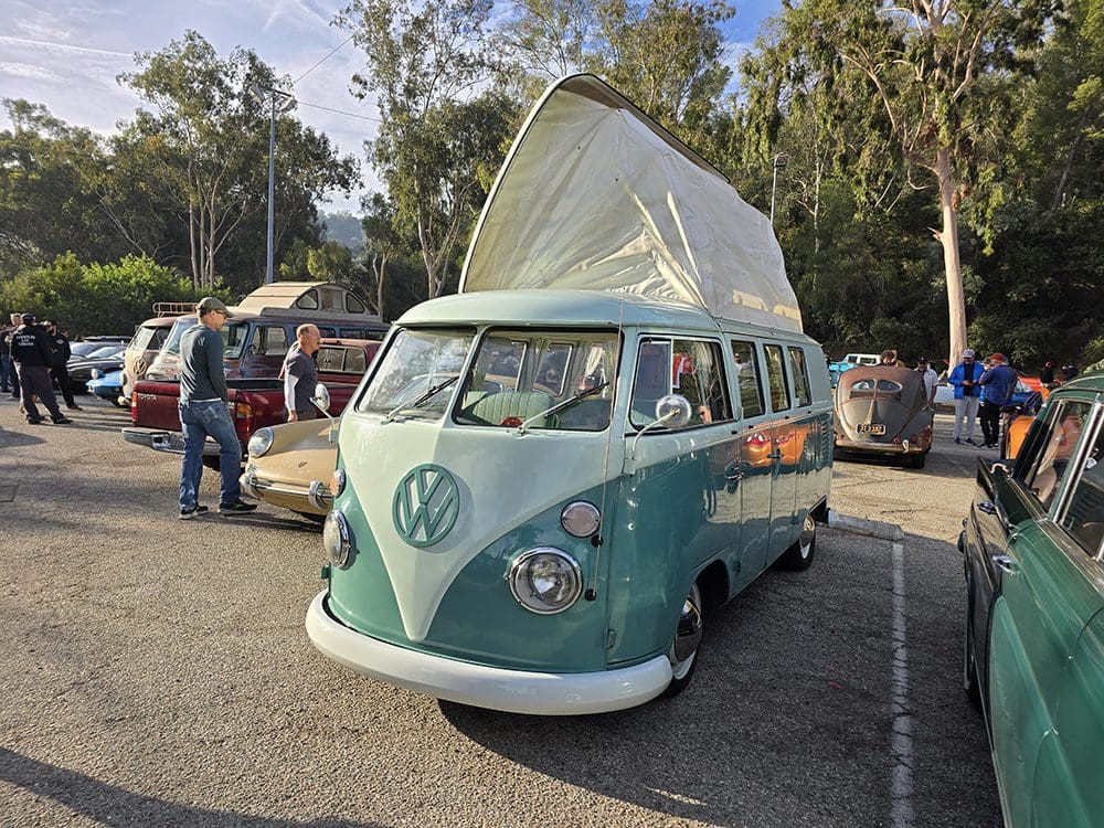 Vintage van with pop-up roof, parked.