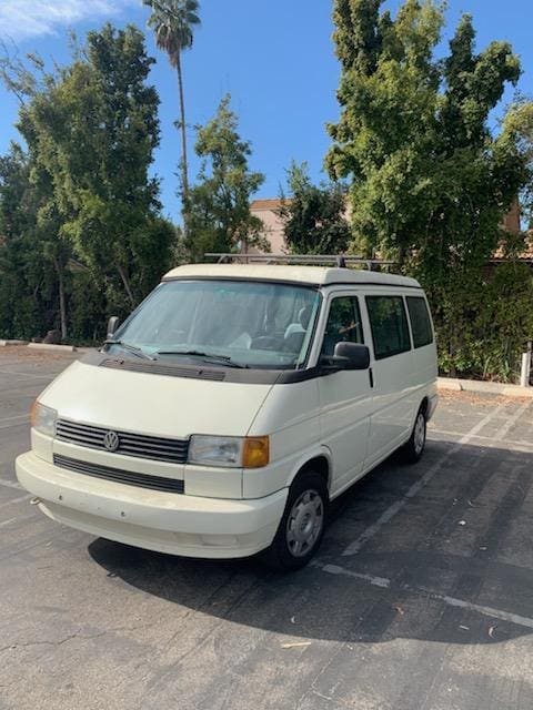 White van parked in outdoor lot.
